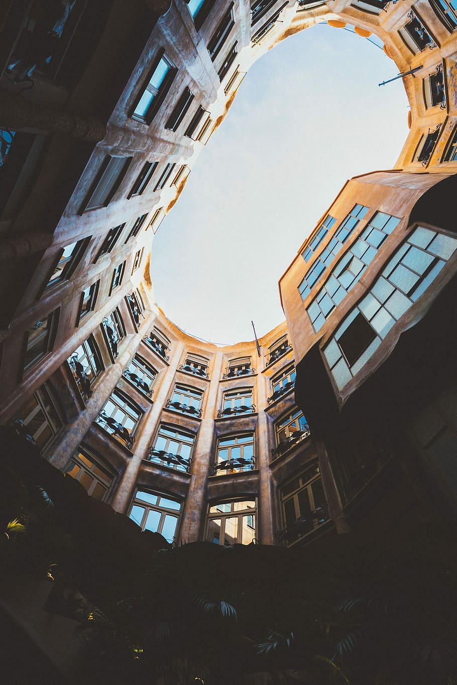 worm's eyeview photo of oval high-rise building ceiling, worms eyeview of brown concrete building HD wallpaper