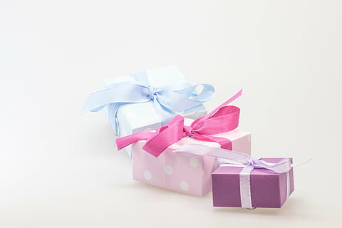 three pink, purple, and blue gift boxes on white background HD wallpaper