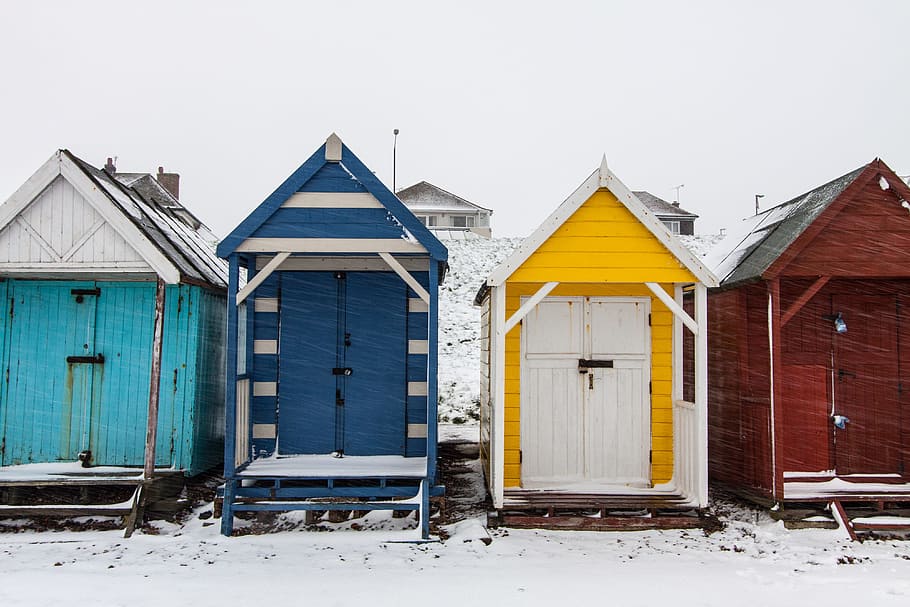 Winter-time scene of snow covered beach huts on the Kent Coast in Southern England HD wallpaper
