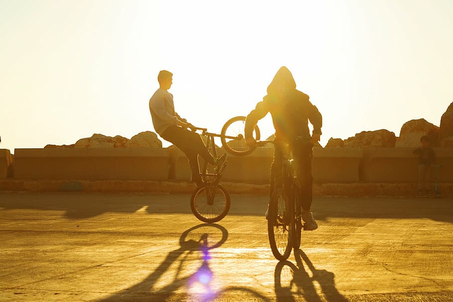 two person riding a bicycle doing tricks, sport, bike, biking