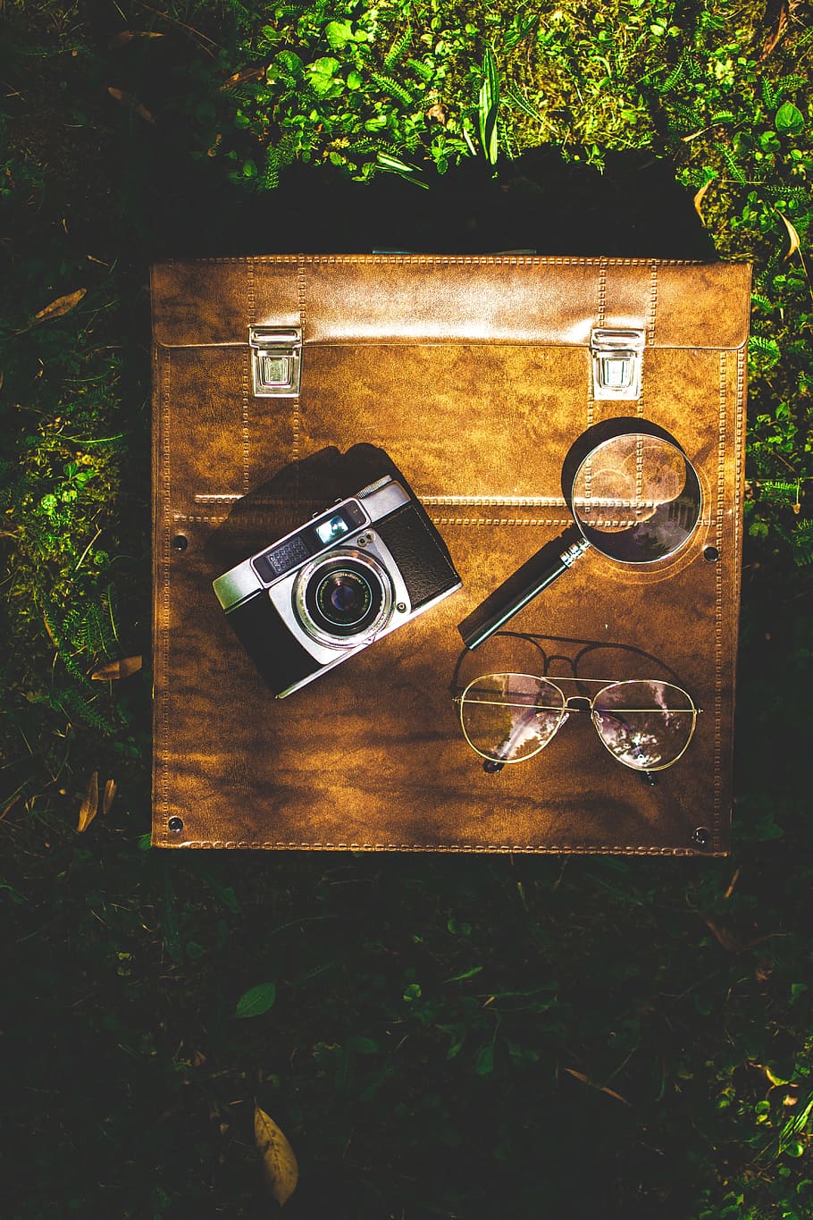 black and silver point-and-shoot camera beside magnifying glass HD wallpaper