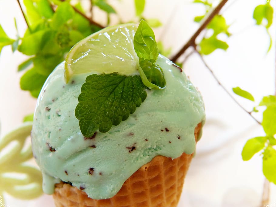 green ice cream with slice lime on top, ice cream cone, peppermint