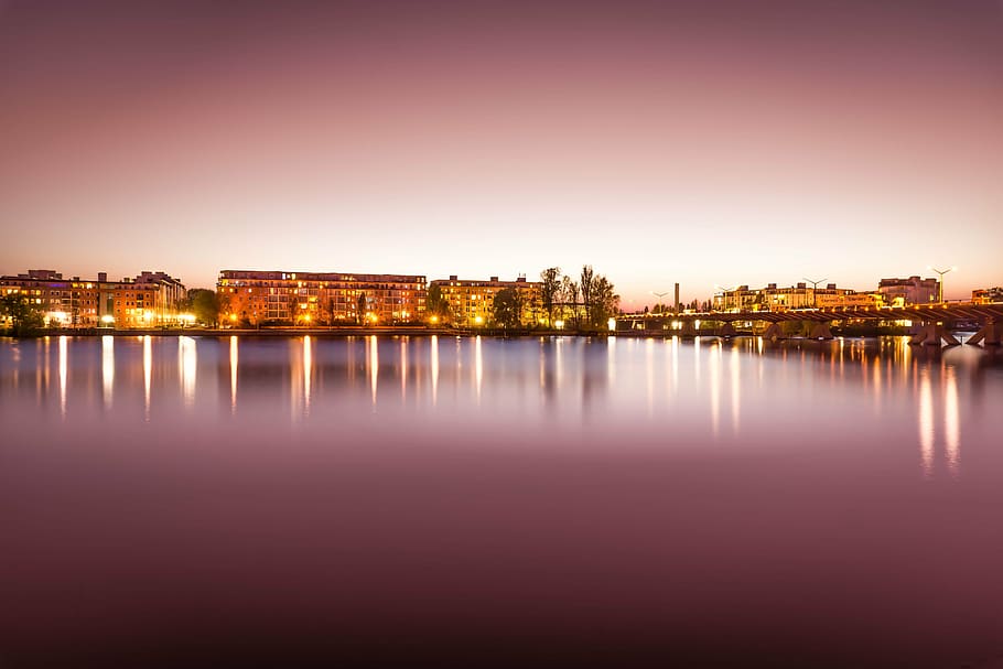 body of water beside lighted concrete buildings, architecture HD wallpaper
