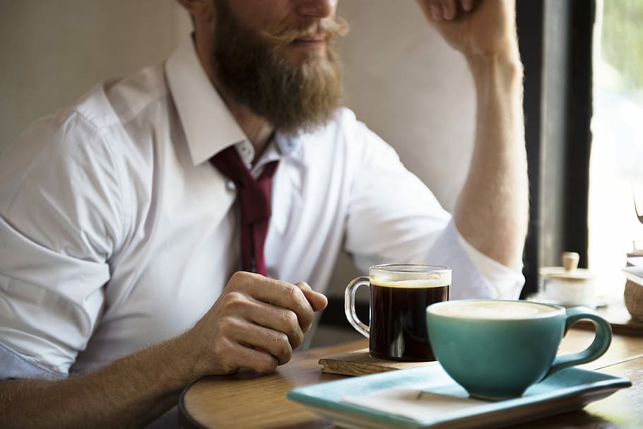 man sitting in front of table with coffee on top of it, Beard HD wallpaper