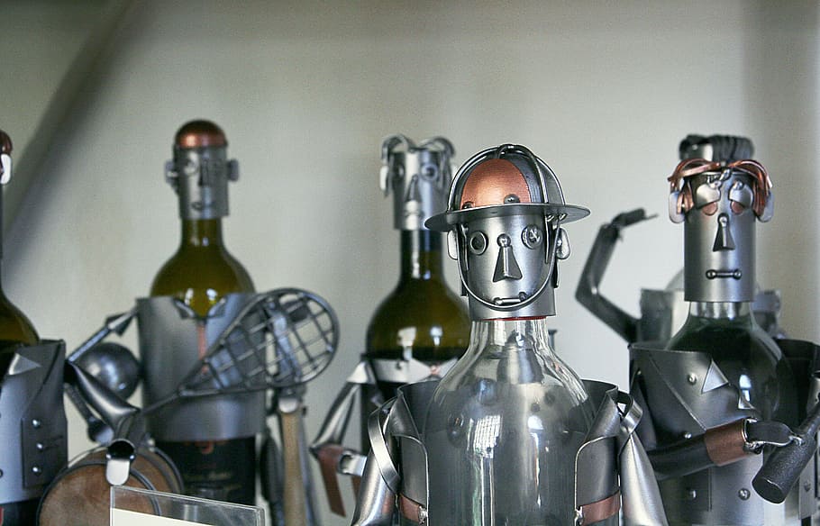 five gray-and-brown metal robots, silver soldier decors, bottle