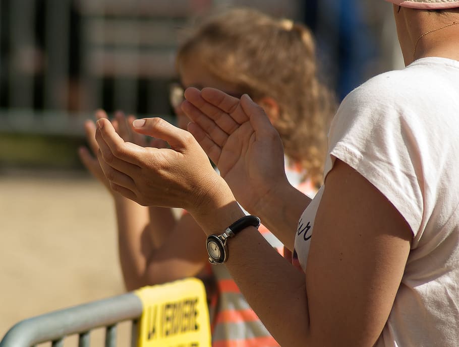 woman standing beside girl near gray fence during daytime, spectators HD wallpaper