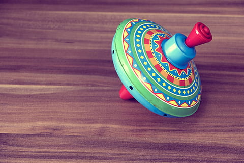 multicolored plastic spinning top toy on wooden surface, coloured HD wallpaper
