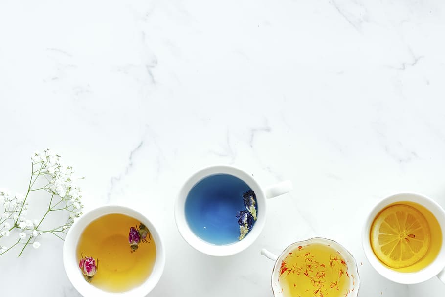 flat lay photography of assorted color four teacups of beverage HD wallpaper