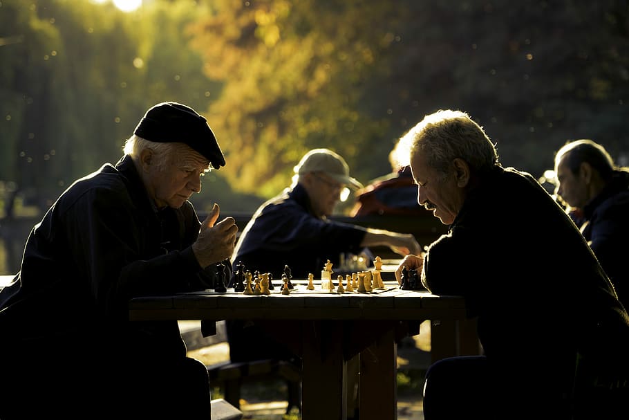 two man playing chess in shallow focus lens, two men playing chess