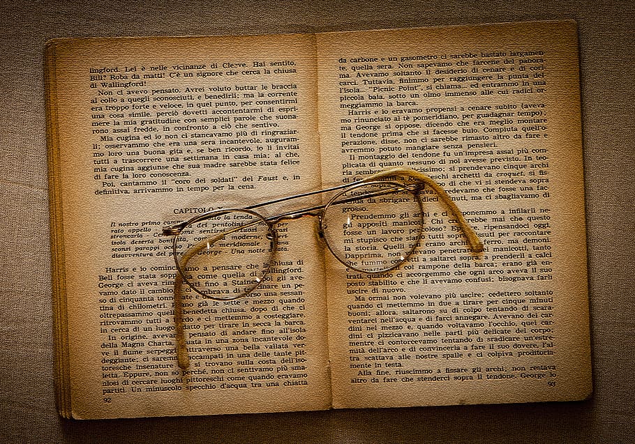 eyeglasses with silver frames on beige book pages, ancient HD wallpaper