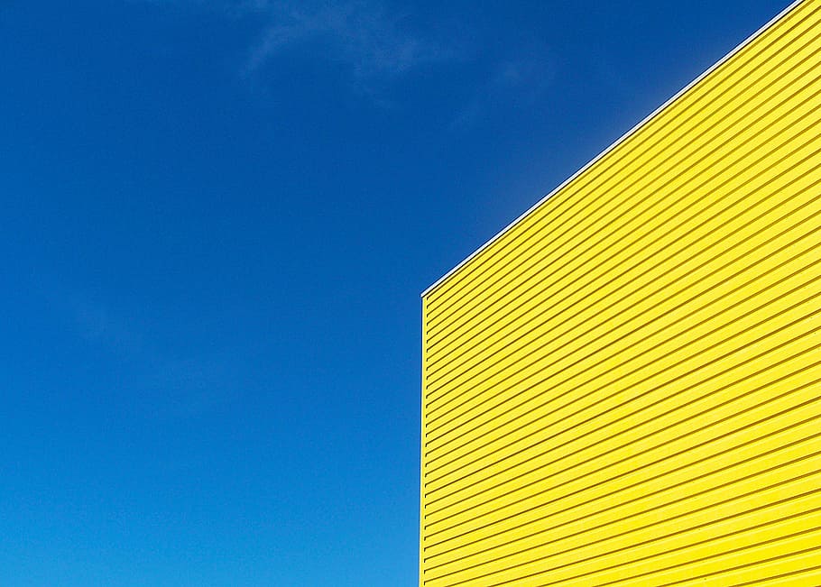 yellow painted building under blue sky during daytime, contrast HD wallpaper