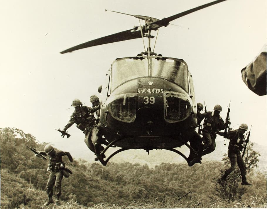 grayscale photo of soldiers jumping off helicopter, bell uh-1