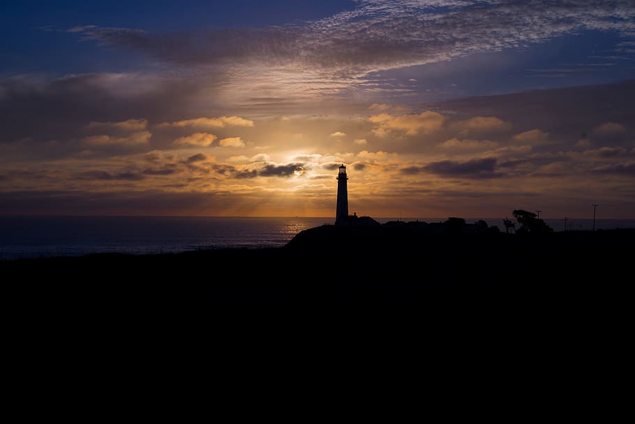 silhouette photography of lighthouse under alto cirrus clouds and sunset HD wallpaper