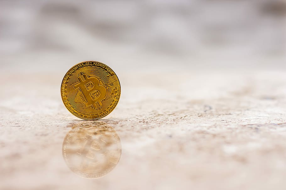 round gold-colored coin in shallow focus photography, bitcoin