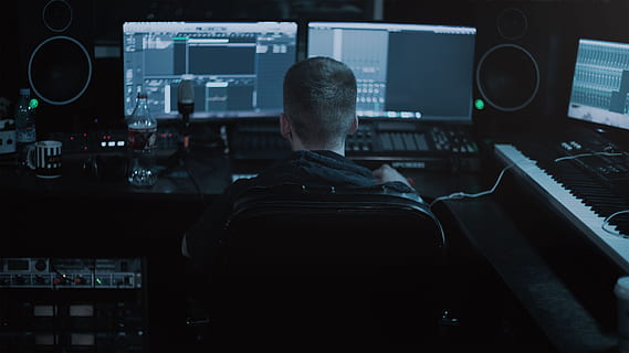 person sitting in front of computer monitors, at computer, guy HD wallpaper