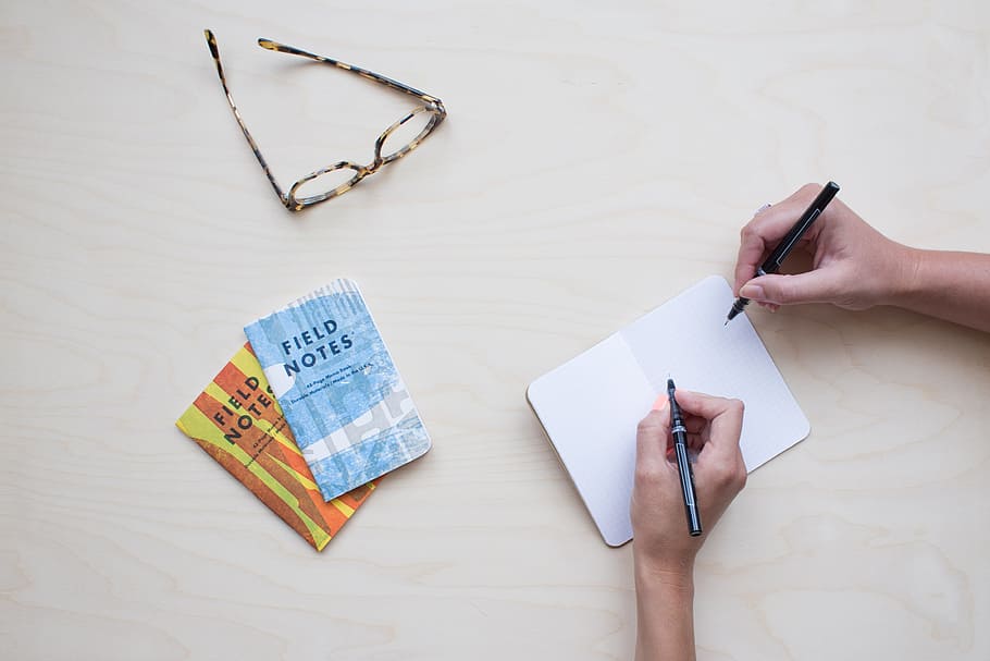 flat lay photography of two persons writing notes, glasses HD wallpaper