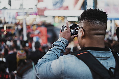 selective focus photography of man capturing people using DSLR camera during daytime, man holding DSLR camera HD wallpaper