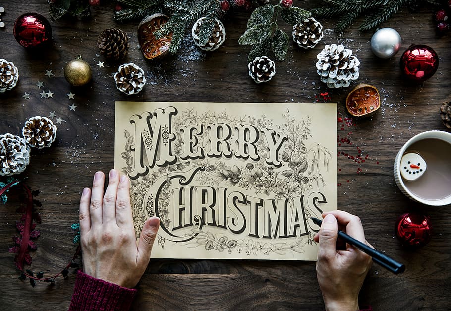 person drafting Merry Christmas signage and decors on table, card, HD wallpaper