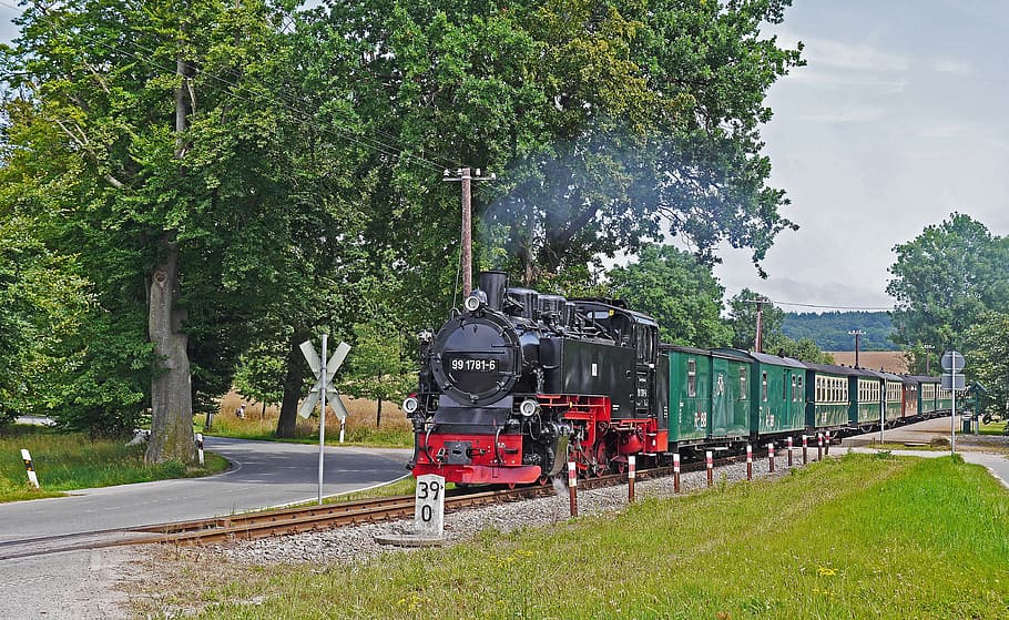 red, black, and green train on rails, rasender roland, rügen island