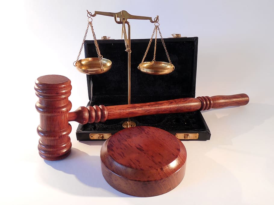 brown gavel and brass-colored balancing scale, hammer, horizontal