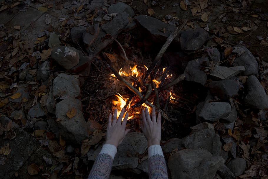photography of person warming his/her hands at bonfire, person near on bonfire during nighttime HD wallpaper