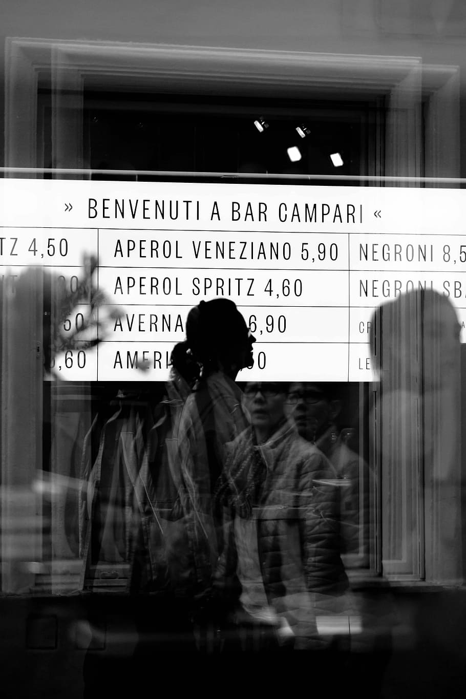 reflection of people from glass panel walking and passing signage in grayscale photography, grayscale photo of man standing near clear glass panel HD wallpaper