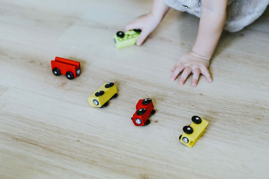 Child playing with toys on the floor, fun, car, kid, game, wood - Material