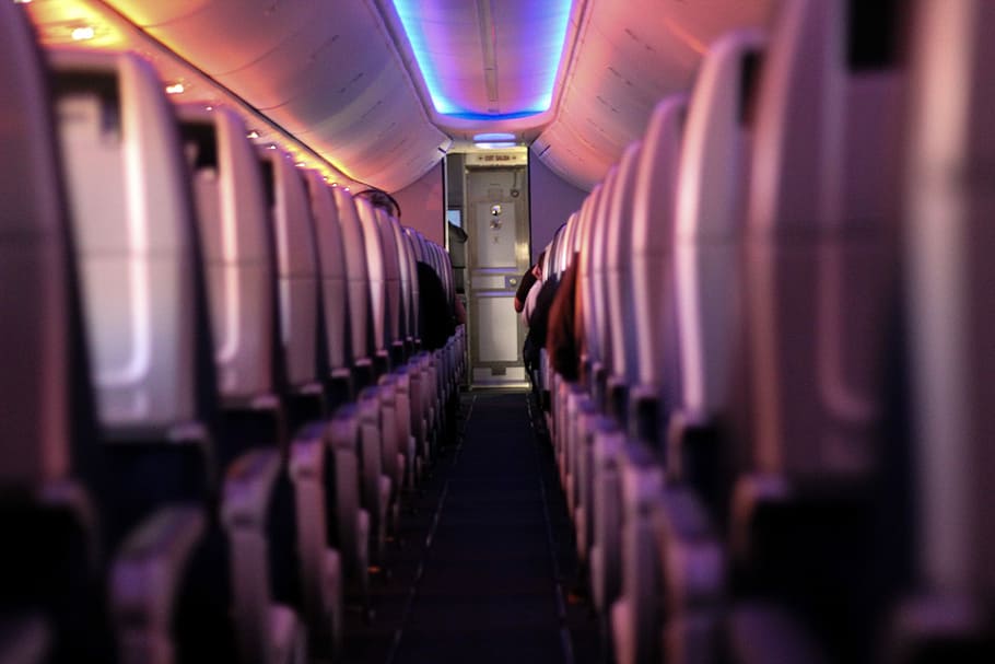 shallow focus photography of airplane seats, walkway inside plane