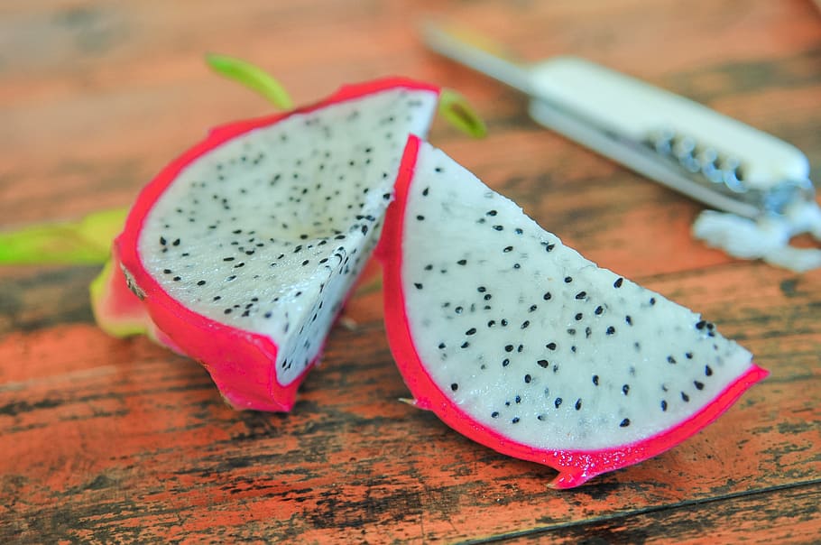 sliced pitaya fruit placed on brown wood, dragonfruit, pink HD wallpaper
