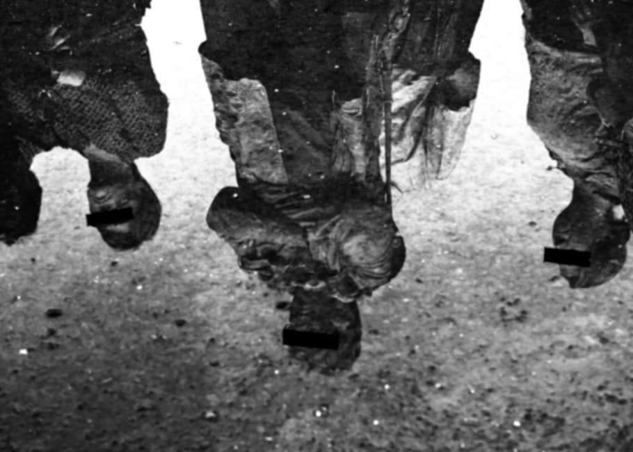 grayscale photograph of four people standing, anonymous, mirroring