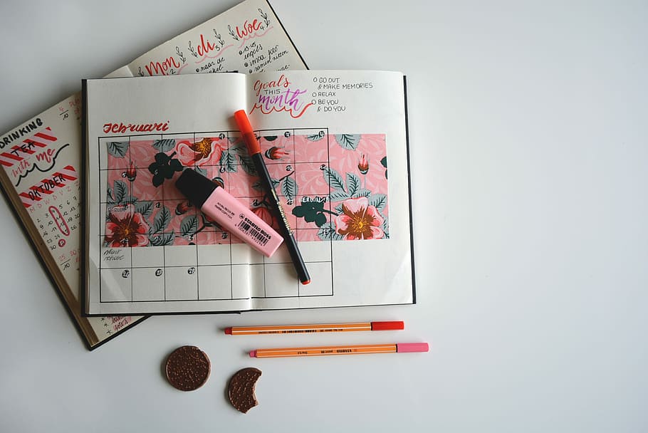 pink highlighter, flat-lay photography of weekly planner with pen and highlights on top HD wallpaper