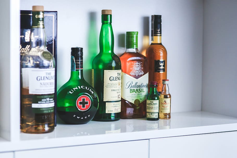 assorted-brand bottles on cabinet, whiskey, alcohol, alcoholism