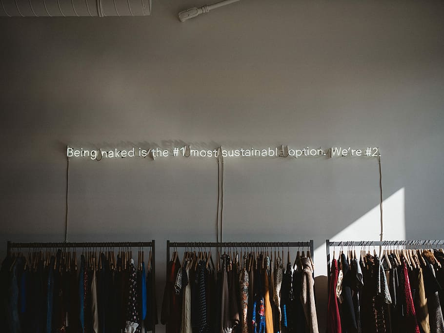 assorted clothes lot on gray clothes racks, assorted-color hanged clothes lot near the wall HD wallpaper