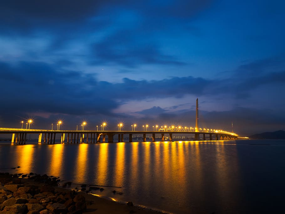 lighted sea bridge above water, photo of bridge during nighttime HD wallpaper