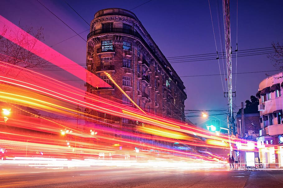 time-lapse photography of cars passing through the road between buildings during night time, timelapse photography of road lights near buildings HD wallpaper