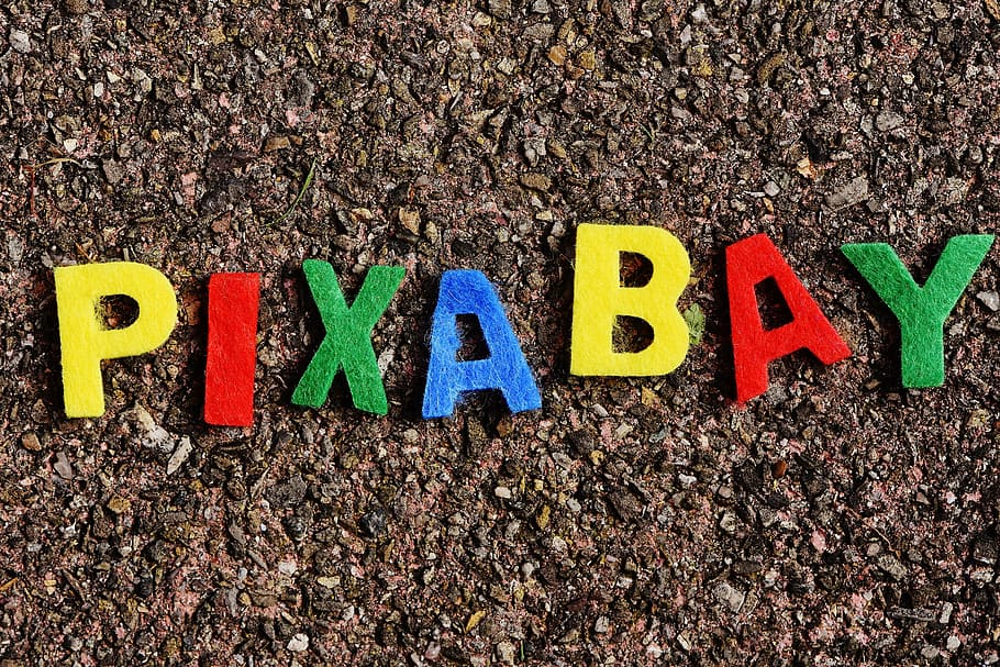 multicolored Pixabay letters on brown sand, image database HD wallpaper