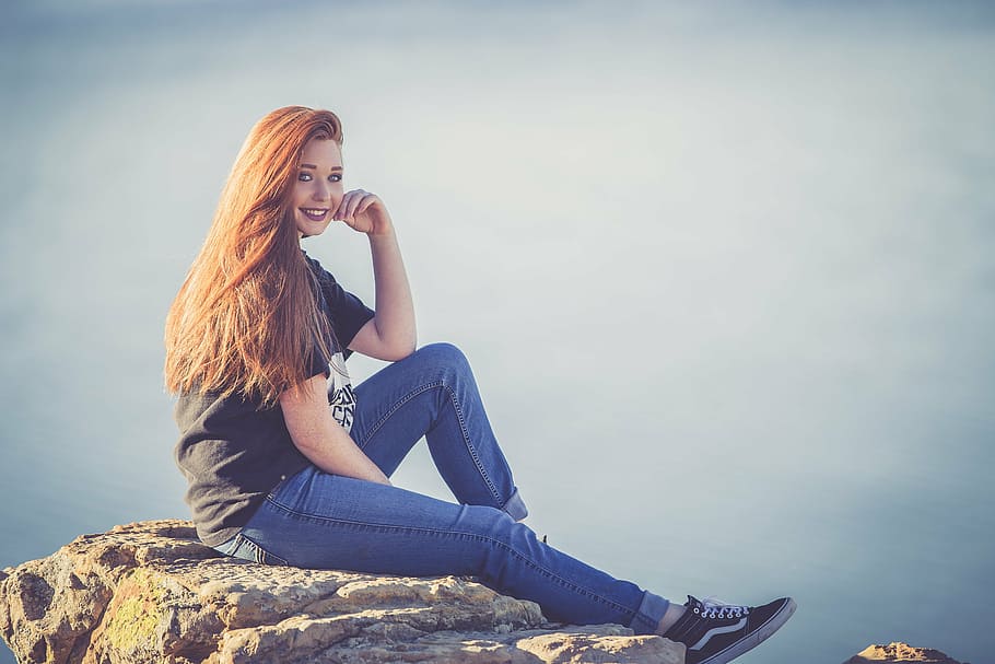 woman sitting on rock on mountain top, redhead, beautiful, girl