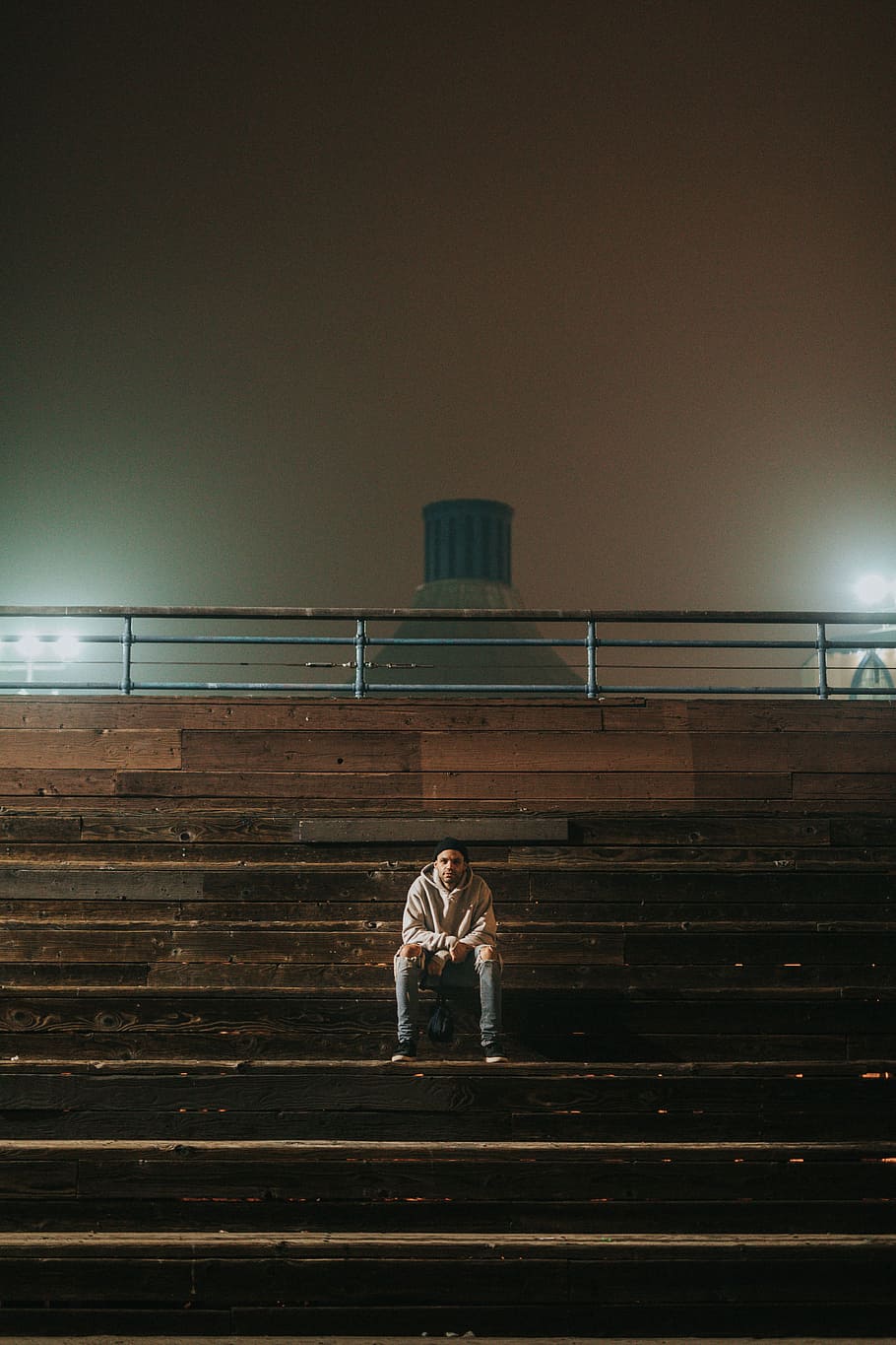 man sitting on bleachers during nighttime, man sitting on bleacher HD wallpaper