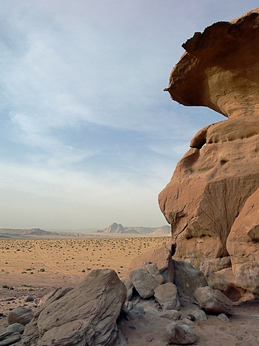 clear sky over rock formation, brown rock formation in desert under blue and white cloudy sky HD wallpaper
