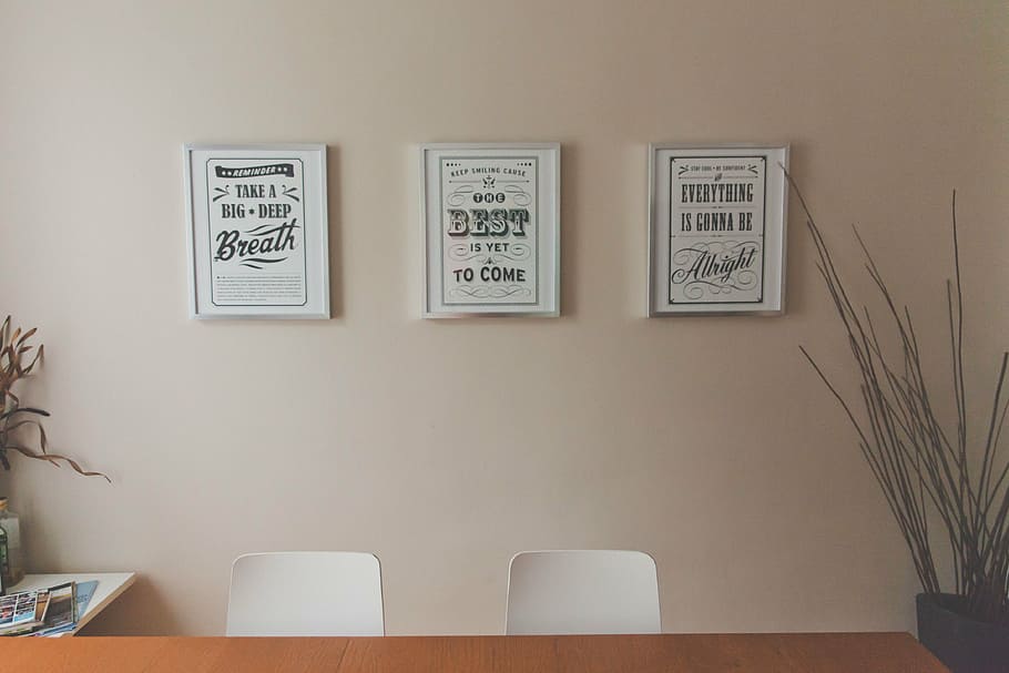closeup photo of three decors on beige wall, slogans, framed HD wallpaper