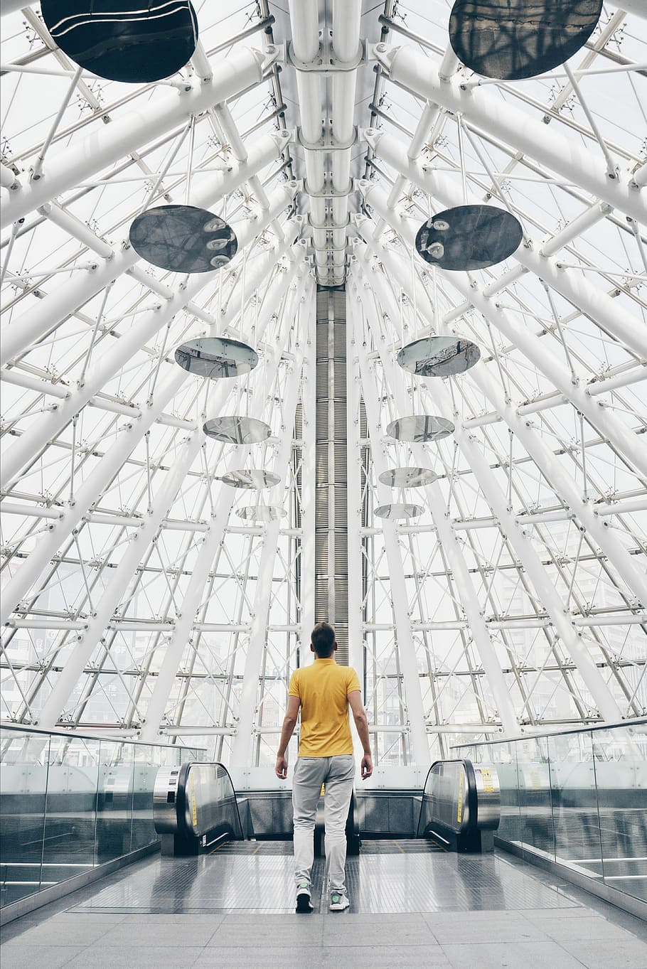 man standing under glass panel dome during daytime, man standing inside building during daytime HD wallpaper