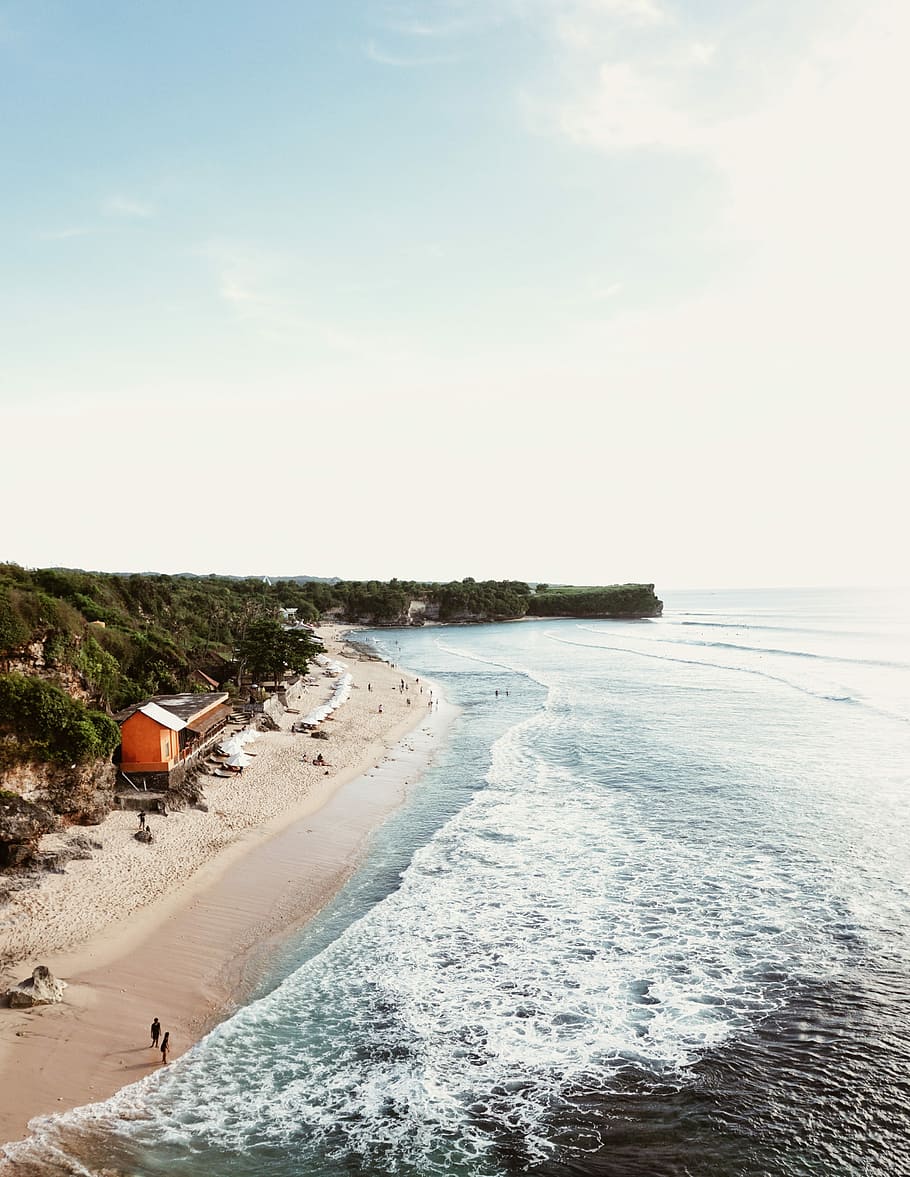 two person walking in the beach, red wooden house near calm ocean at daytime panoramic photography HD wallpaper