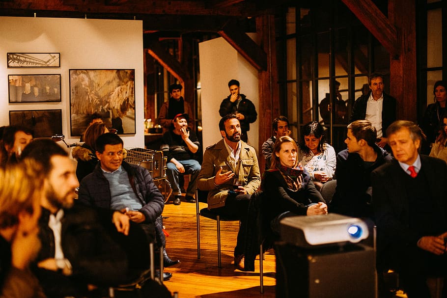 people sitting on chair, group of people inside area filled with artworks HD wallpaper