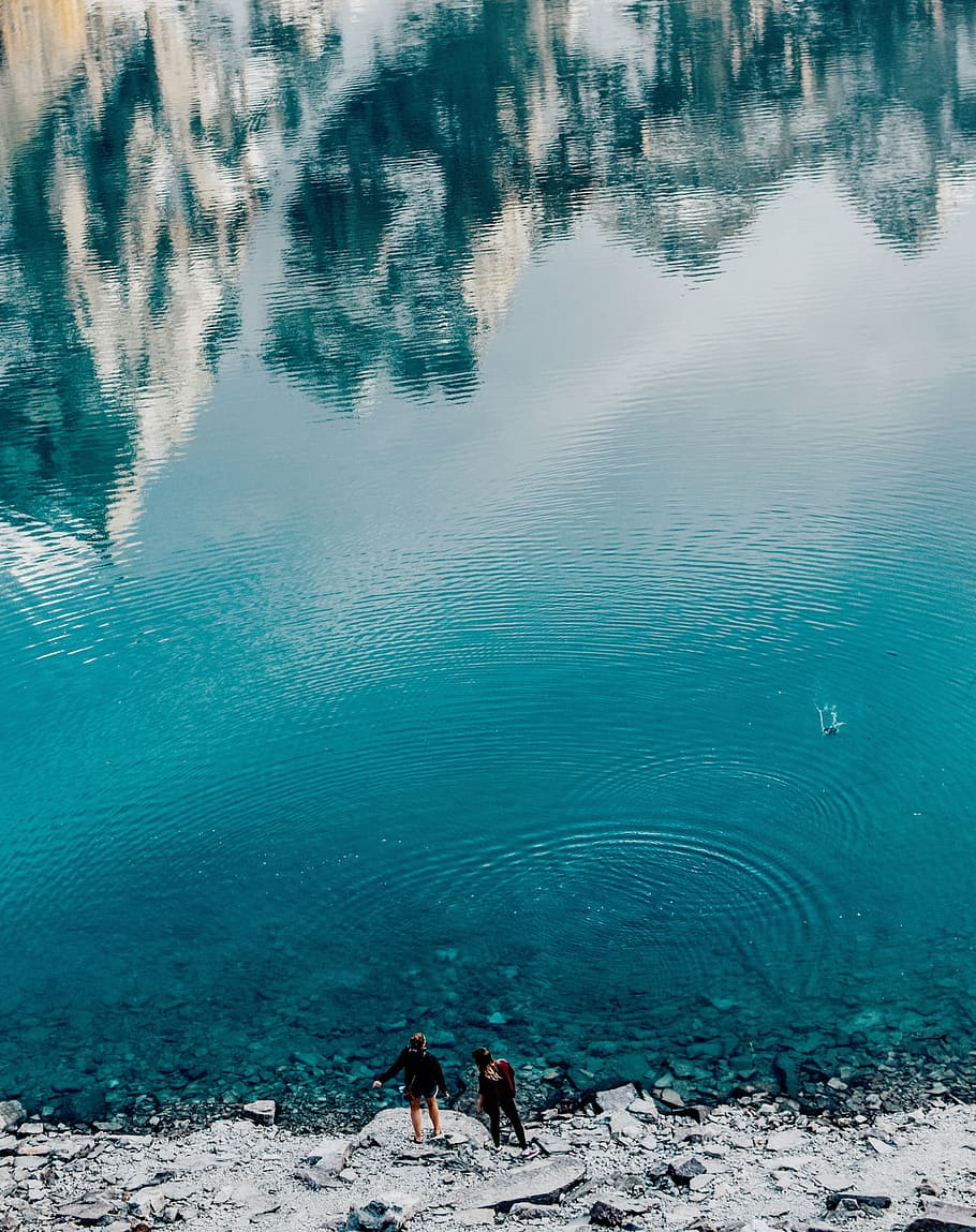 person standing near body of water, nature, reflection, rocks HD wallpaper