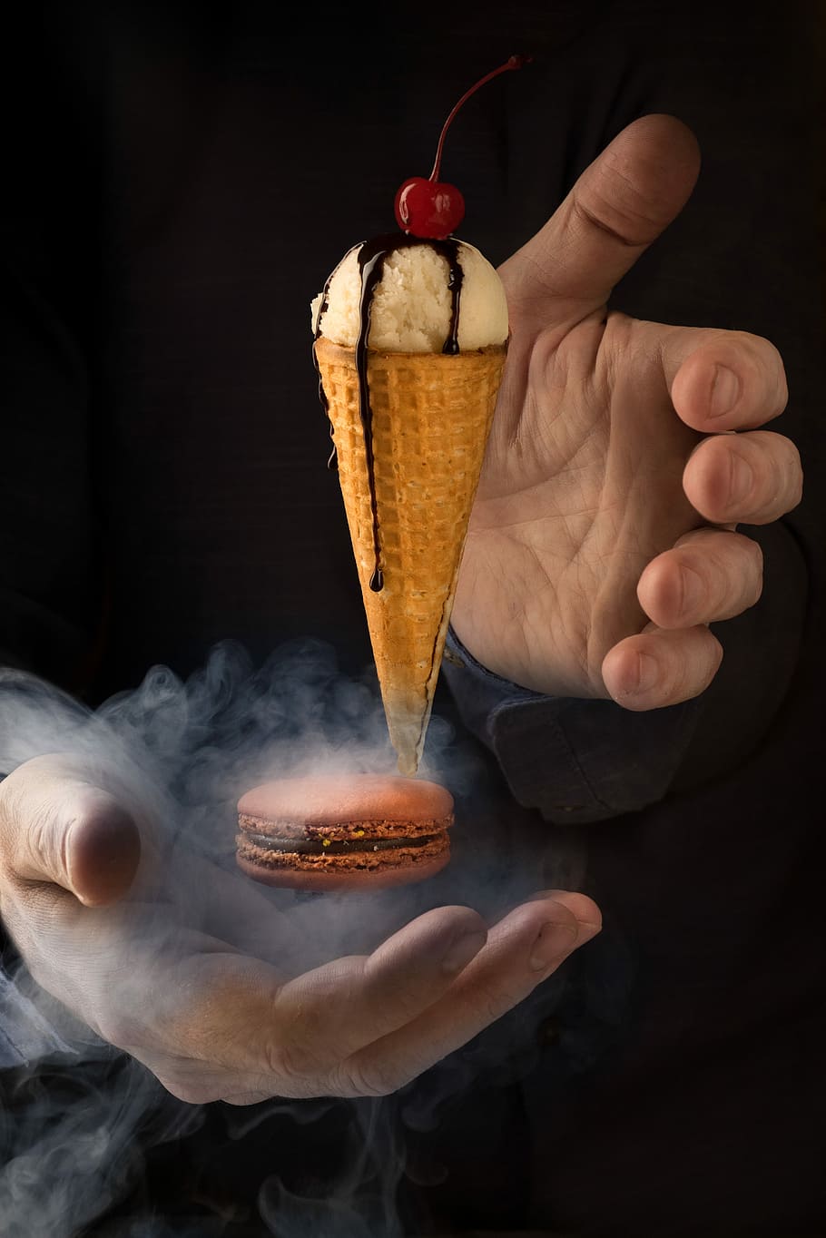 Magic moment, closeup of person's hand beside floating ice cream