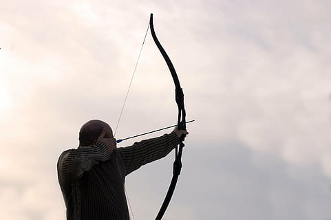 person wearing black long-sleeve top holding long bow, archer HD wallpaper