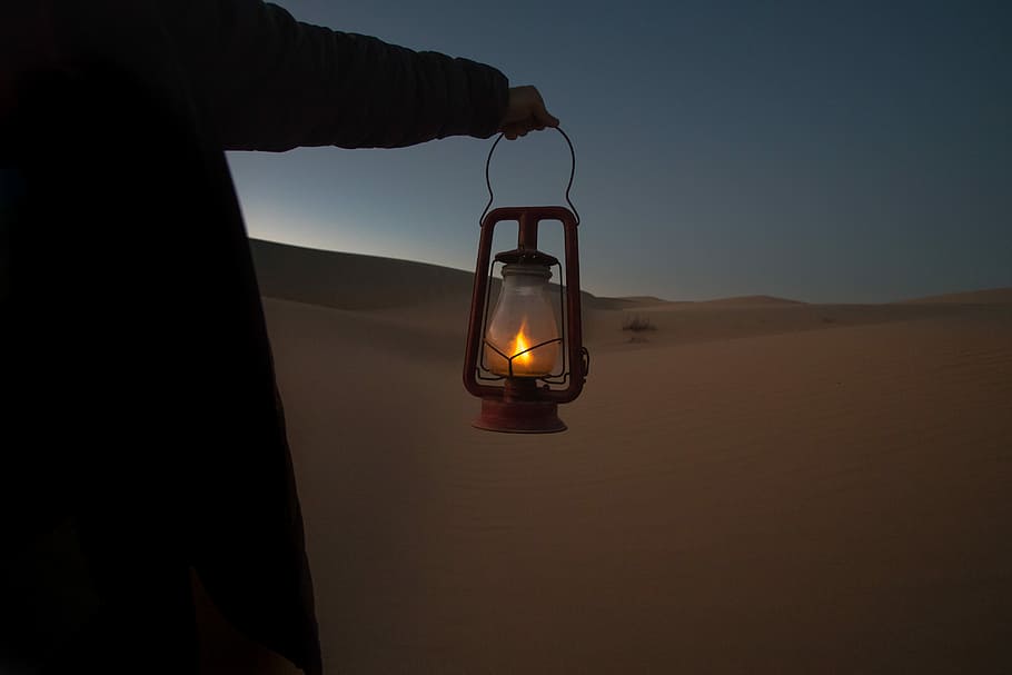 person holding red kerosene lantern, person holding lighted cold blast lantern HD wallpaper