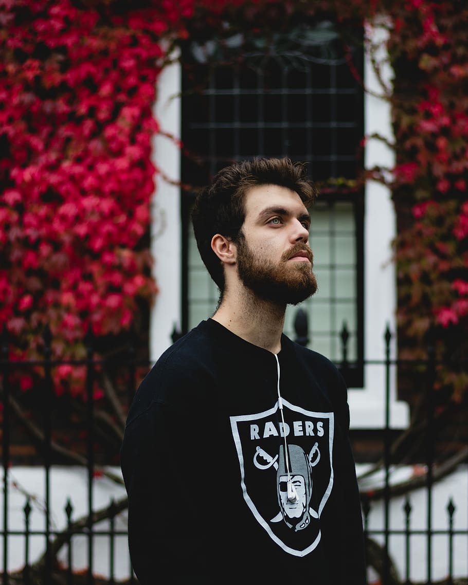 HD wallpaper: man in black Oakland Raiders long-sleeved shirt, man wearing Oakland  Raiders top in front of red petaled trees