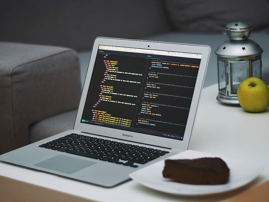 turned on MacBook Air beside saucer with cake on table, MacBook Air near square white ceramic saucer on white wooden table HD wallpaper