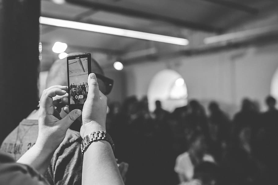 grayscale photo of person taking photo of crowd, cell phone HD wallpaper